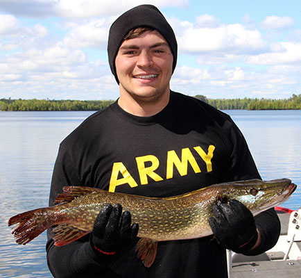 man holding fish he caught