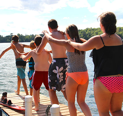 family dancing on dock